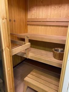 a sauna with wooden shelves and a bowl at Varastotie 1C in Ylivieska