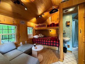 a living room with a couch and a bed in a room at Three Cabins - Pet Friendly & Hot Tub in Warren +64 photos
