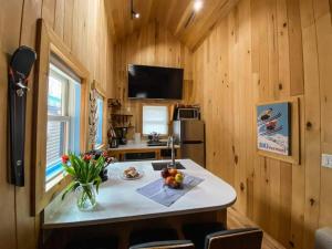 a kitchen with a table in a tiny house at Three Cabins - Pet Friendly & Hot Tub in Warren