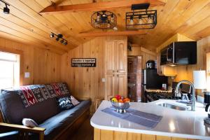 a living room and kitchen in a tiny house at Three Cabins - Pet Friendly & Hot Tub in Warren