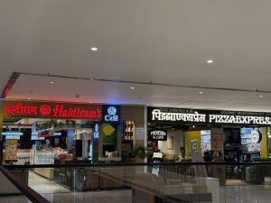a shopping mall with many signs on the ceilings at Nap Junction in Pune +8 photos