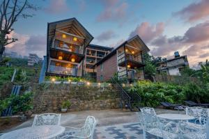 a house on a hill with tables and chairs at Vantage hills Haputale in Haputale +121 photos