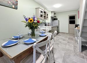 a kitchen and dining room with a table and chairs at le Gîte du Hibou in Rodemack +26 photos