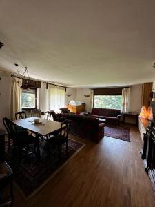 a living room with a table and a couch at Chalet Sofia in San Vito di Cadore