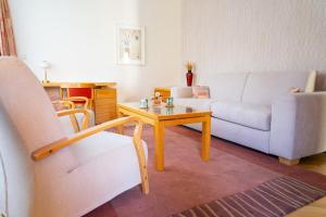 a living room with a couch and a coffee table at Villa Marion in Luhačovice