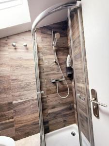 a shower in a bathroom with wooden floors at Rempart du Chateau-SV86 StudioVincennes in Vincennes +20 photos