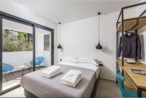 a bedroom with a bed with two towels on it at Villa Lambis Athena in Lindos +23 photos