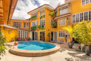 an exterior view of a house with a swimming pool at Hotel Serra Nova in Cajamarca