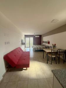 a living room with a red couch and a bed at Vanguardia Suites in San Juan