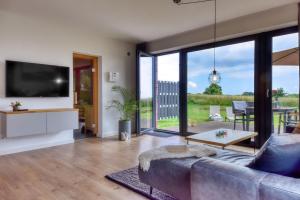 a living room with a couch and a tv at Ferienhaus Backsteinquartier D in Putbus mit Sauna und Kamin in Putbus