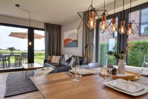 a living room with a table and a couch at Ferienhaus Backsteinquartier D in Putbus mit Sauna und Kamin in Putbus