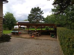 a pavilion with a picnic table in a park at Ferienwohnung Pferdestall in Reinhardtsdorf +4 photos