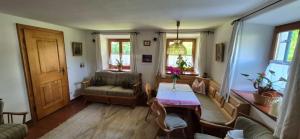 a living room with a table and a couch at Ferienwohnung Diechtler inkl. Chiemgaukarte in Ruhpolding