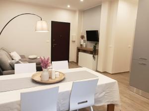 a living room with a table and a couch at Quick Home - Edera in Biella