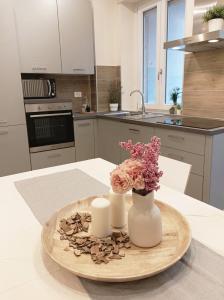 a kitchen with two candles and flowers on a plate at Quick Home - Edera in Biella