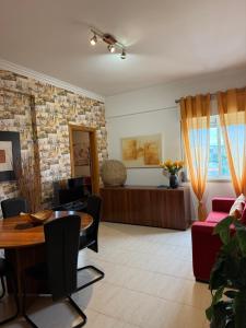 a living room with a table and a couch at My apartment in Sacavém in Sacavém