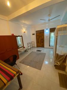 a large living room with a ceiling fan and a room at DEMITHA guest in Ranna +2 photos