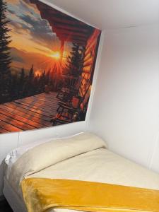 a bedroom with a wall painting of a cabin at Tiny wooden home in Vega Baja +17 photos