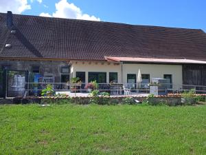 a house with a patio and a yard at Wohnen am Schliestedter Bach b in Schöppenstedt +1 photo