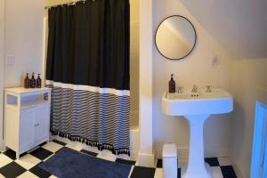a bathroom with a sink and a shower curtain at Hike, Bike, & Explore: Vermont Family Farmhouse! in New Haven +30 photos