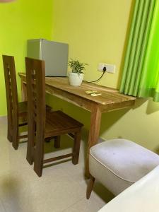 a wooden table with a mirror and a chair at DEMITHA guest in Ranna