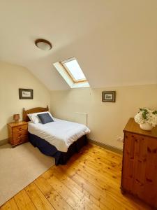 a bedroom with a bed and a skylight at The Willows in Kerry in Tralee