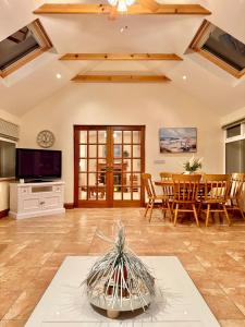 a living room with a table and a tv at The Willows in Kerry in Tralee