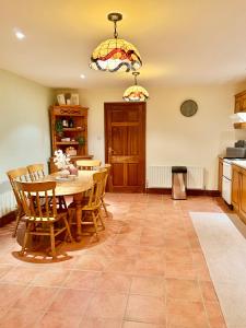 a kitchen with a table and chairs and a dining room at The Willows in Kerry in Tralee