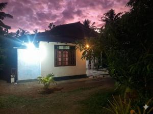 a house at night with a cloudy sky at KADUPUL Hiriketiya in Hiriketiya