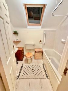 a bathroom with a toilet and a tub and a sink at The Willows in Kerry in Tralee +33 photos