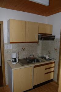 a kitchen with a sink and a counter top at Residence Rastbichl - Apartments & Indoor-Pool in Maranza