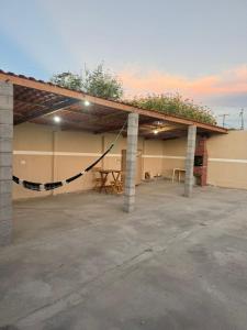 a garage with awning with a picnic table in it at Edilson santos in João Pessoa