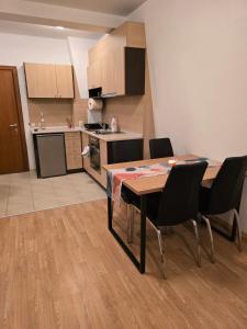 a kitchen and dining room with a table and chairs at AspenValley Aprtment in Razlog