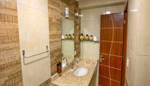 a bathroom with a sink and a mirror at Nega Joana in Araruna +33 photos