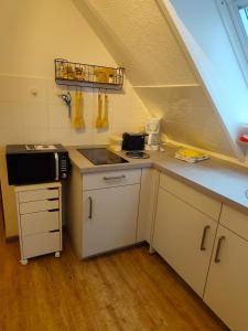 a small kitchen with a sink and a stove at Apartment 10 in Surwold