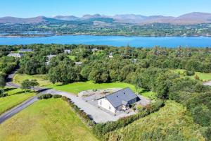 an aerial view of a house with a lake at Bun Cill Athat in Kenmare