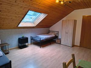 a bedroom with a bed and a skylight at Hostel Fantasy in Gröbenzell