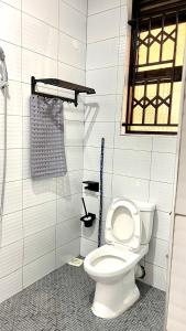 a bathroom with a white toilet in a stall at Muyenga Studio Apartments in Kampala +11 photos