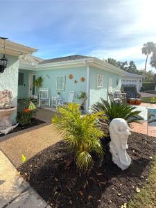 a house with a statue in front of it at The little Manatee Retreat in Orlando