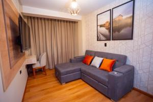 a living room with a couch and a flat screen tv at Samaran Wuasi in Puno