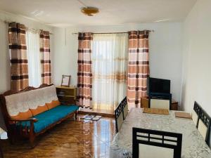 a living room with a couch and a tv at Shalom Villa 2 in Vacoas