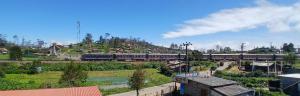 a train is traveling down the tracks in a town at Daya Guest House in Pattipola