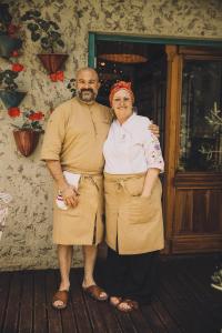 a man and a woman standing in front of a building at Samay Huasi - Cabañas y Casa de Te in Chapadmalal +289 photos