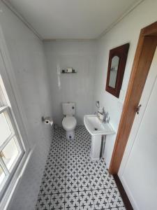 a bathroom with a white toilet and a sink at Viveash - Historic accommodation with Ensuite in Hoddy Well
