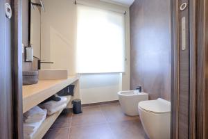 a bathroom with a toilet and a sink at 1029 GuestHouse in Sora +19 photos