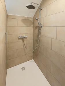 a shower with a shower head in a bathroom at Panorama-Blick Brüggen in Brüggen +24 photos