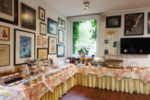 a room with a table with food on it at Hotel Nymphenburg City - München in Munich