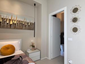 a bedroom with a bed with a yellow pillow on it at Salotto Santa Franca in Piacenza