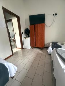 a room with a bathroom with a mirror and a sink at Pousada Matriz 2 in Ouro Fino +8 photos