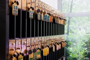 a bunch of wine bottles hanging on a wall at Hotel Nymphenburg City - München in Munich
